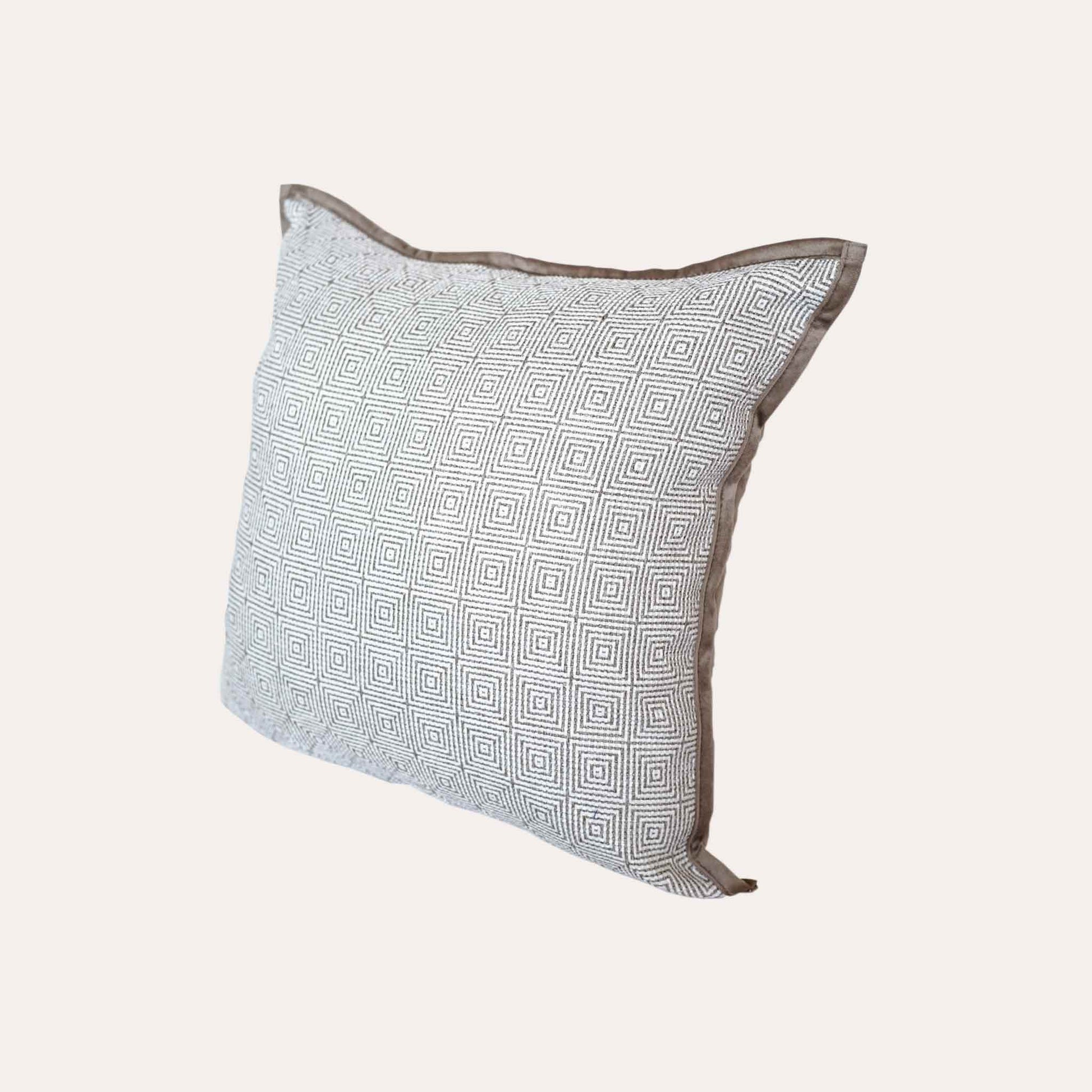Retro luxury cushion cover with beige-brown geometric design on a neutral background