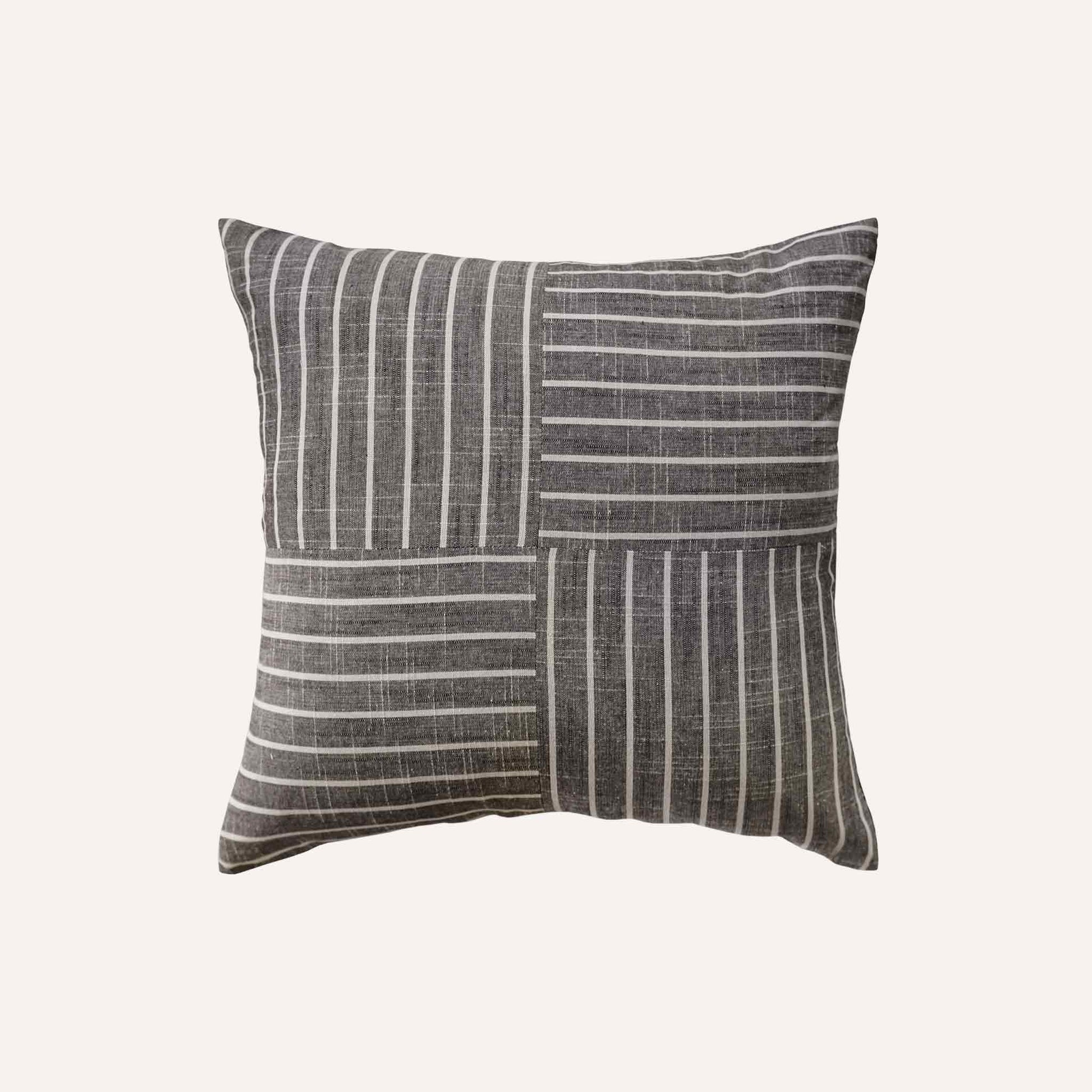 White striped pattern cushion on grey background.