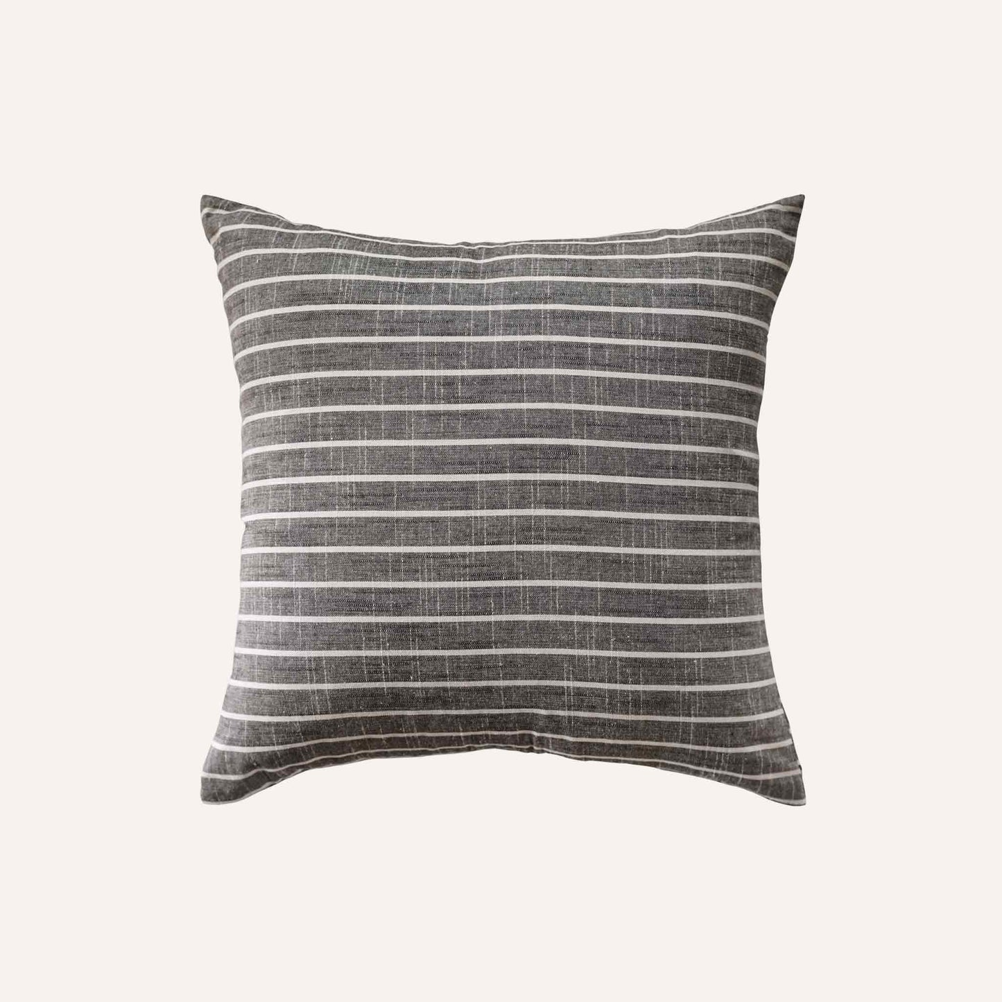 White striped pattern cushion on grey background.