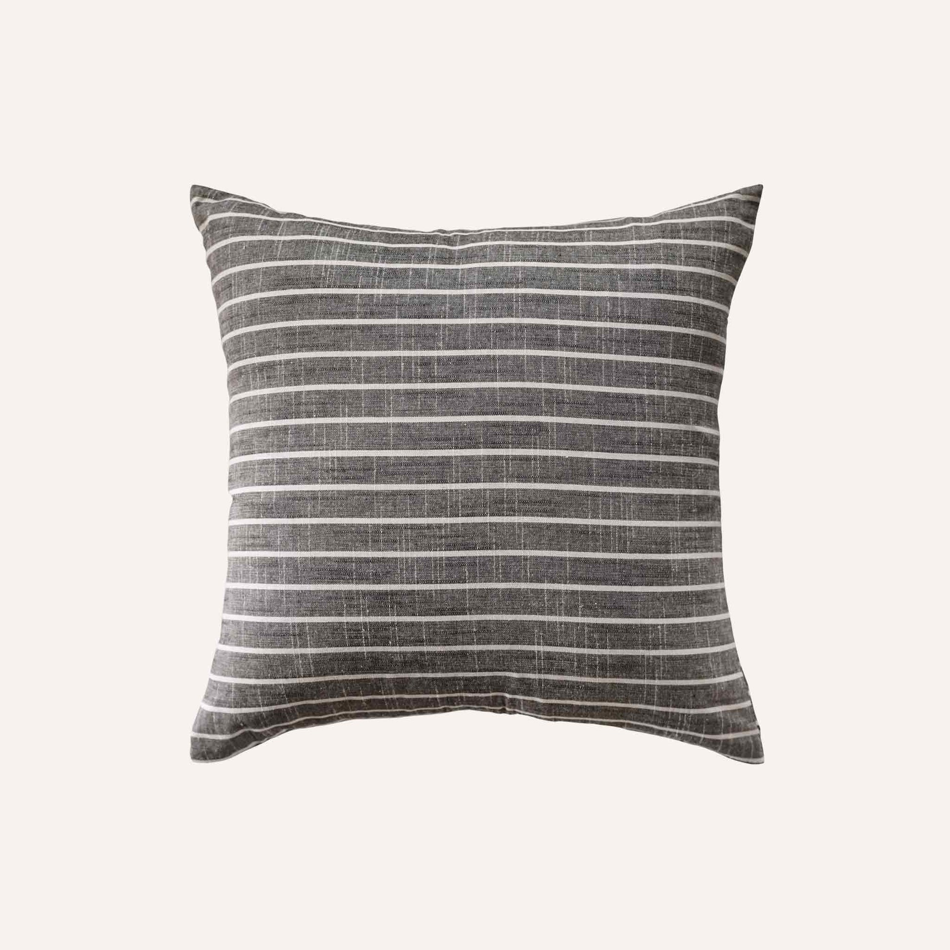 White striped pattern cushion on grey background.