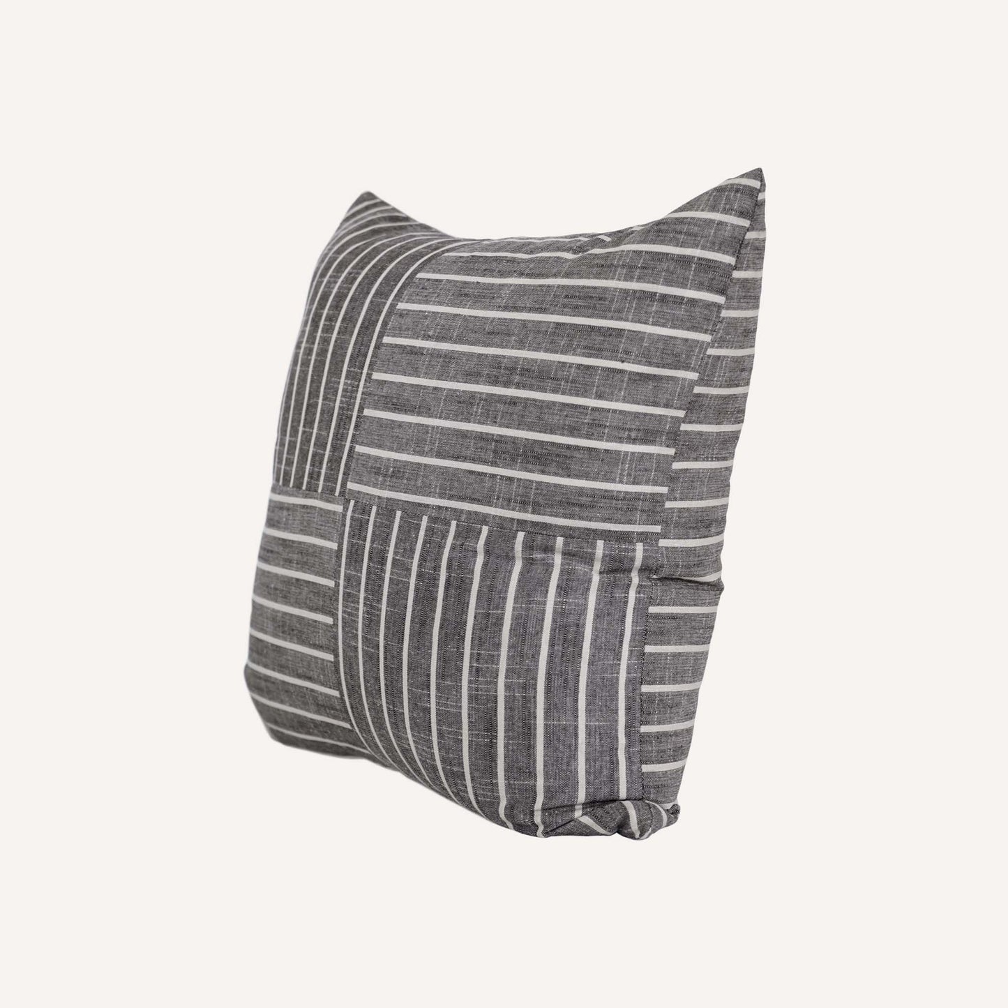 White striped pattern cushion on grey background.