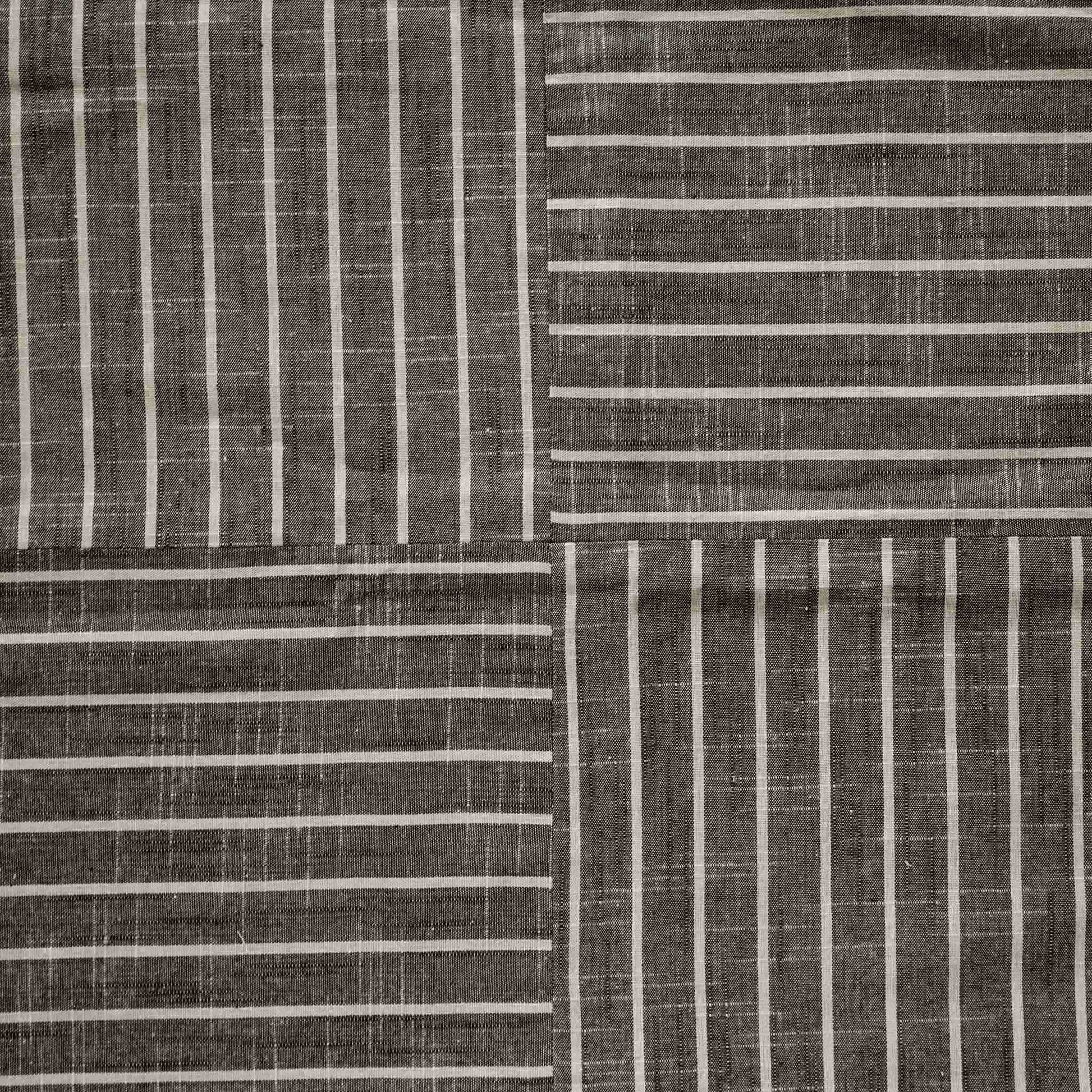 White striped pattern cushion on grey background.