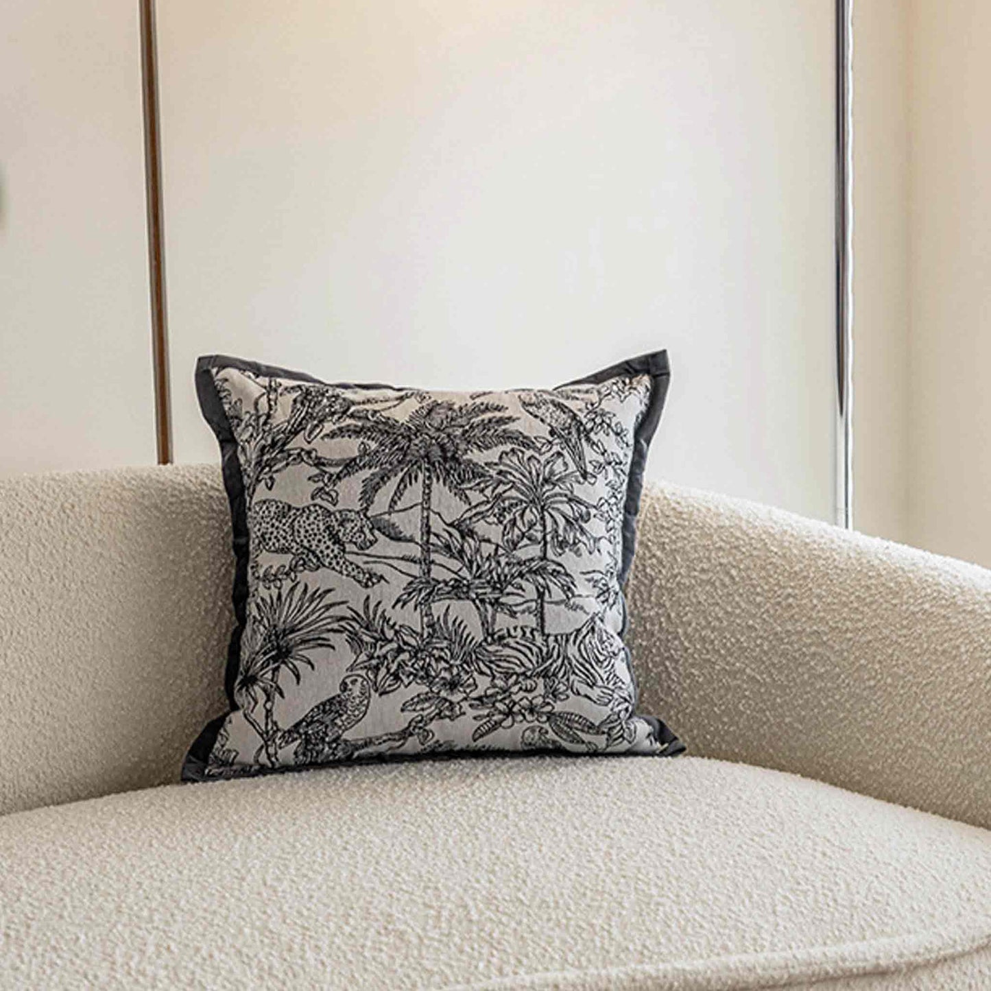 Black and white jungle animal jacquard, black wide border cushion on sofa.