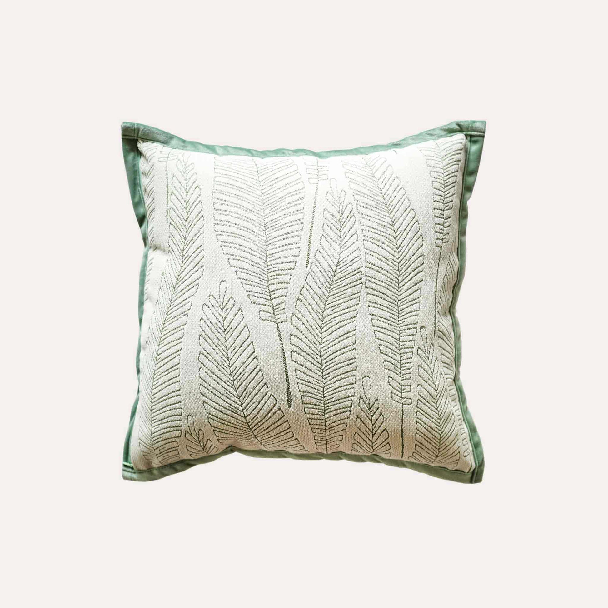 Vibrant green and white palm leaf jacquard cushion cover.