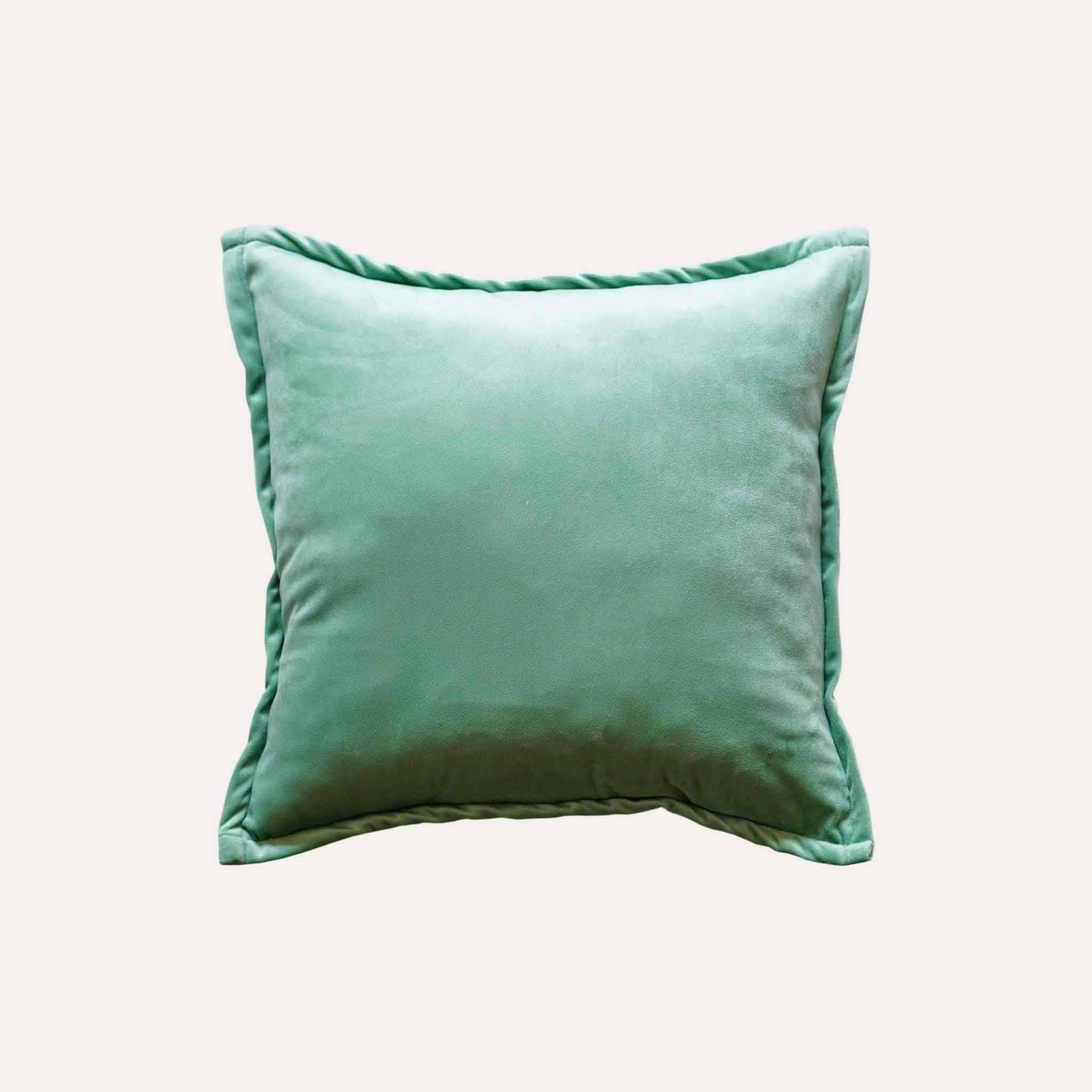 Vibrant green and white palm leaf jacquard cushion cover with green back.
