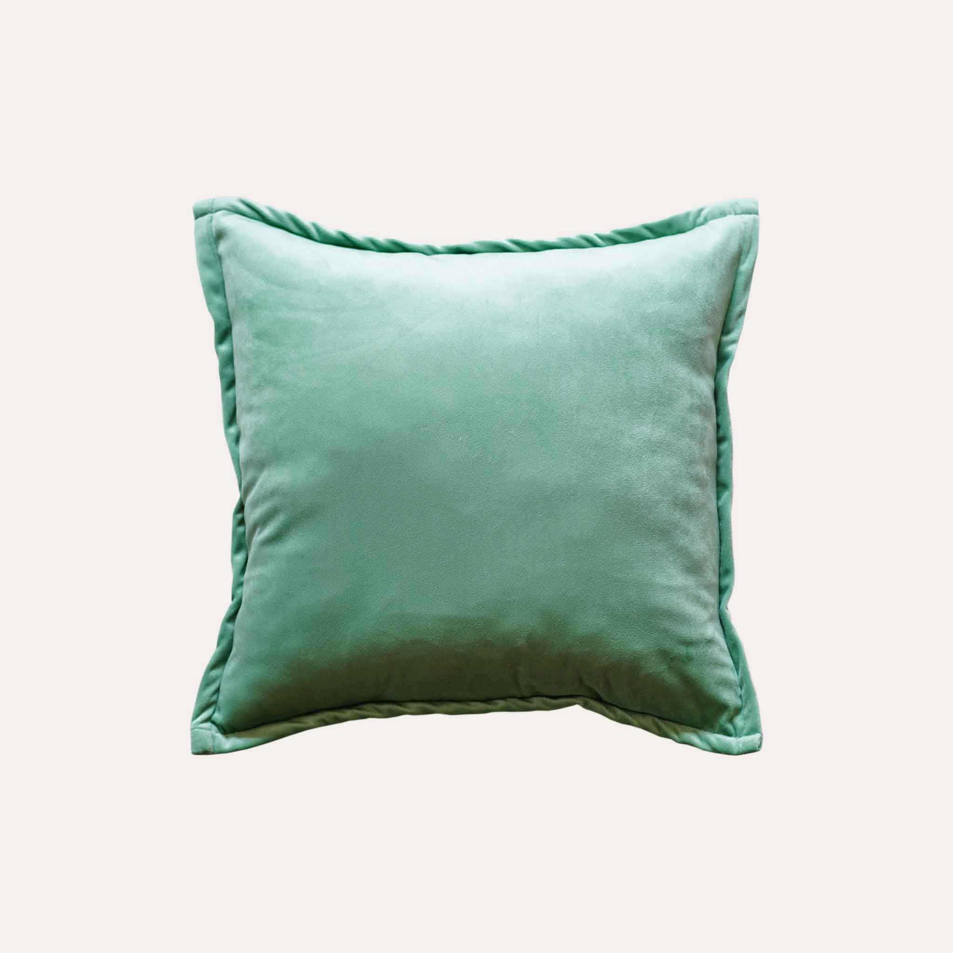 Vibrant green and white palm leaf jacquard cushion cover with green back.
