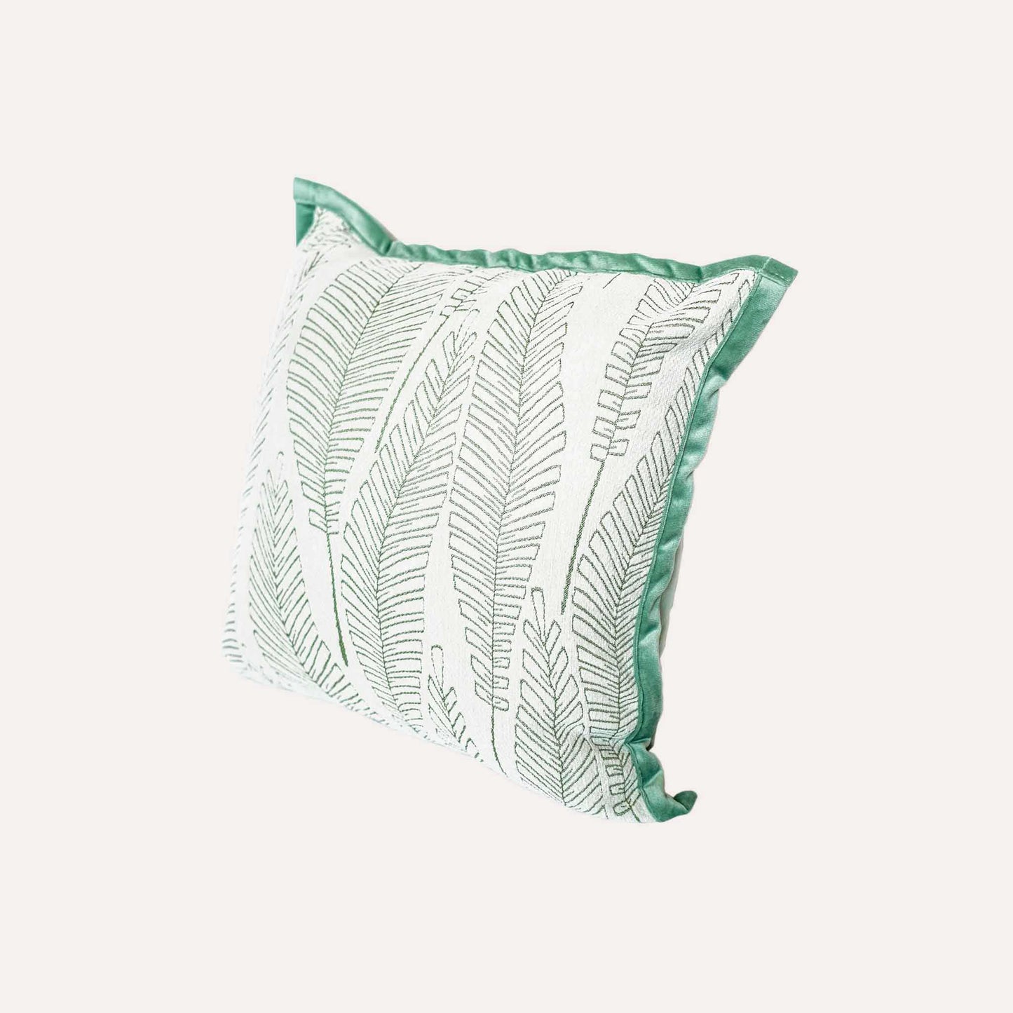 Vibrant green and white palm leaf jacquard cushion cover.