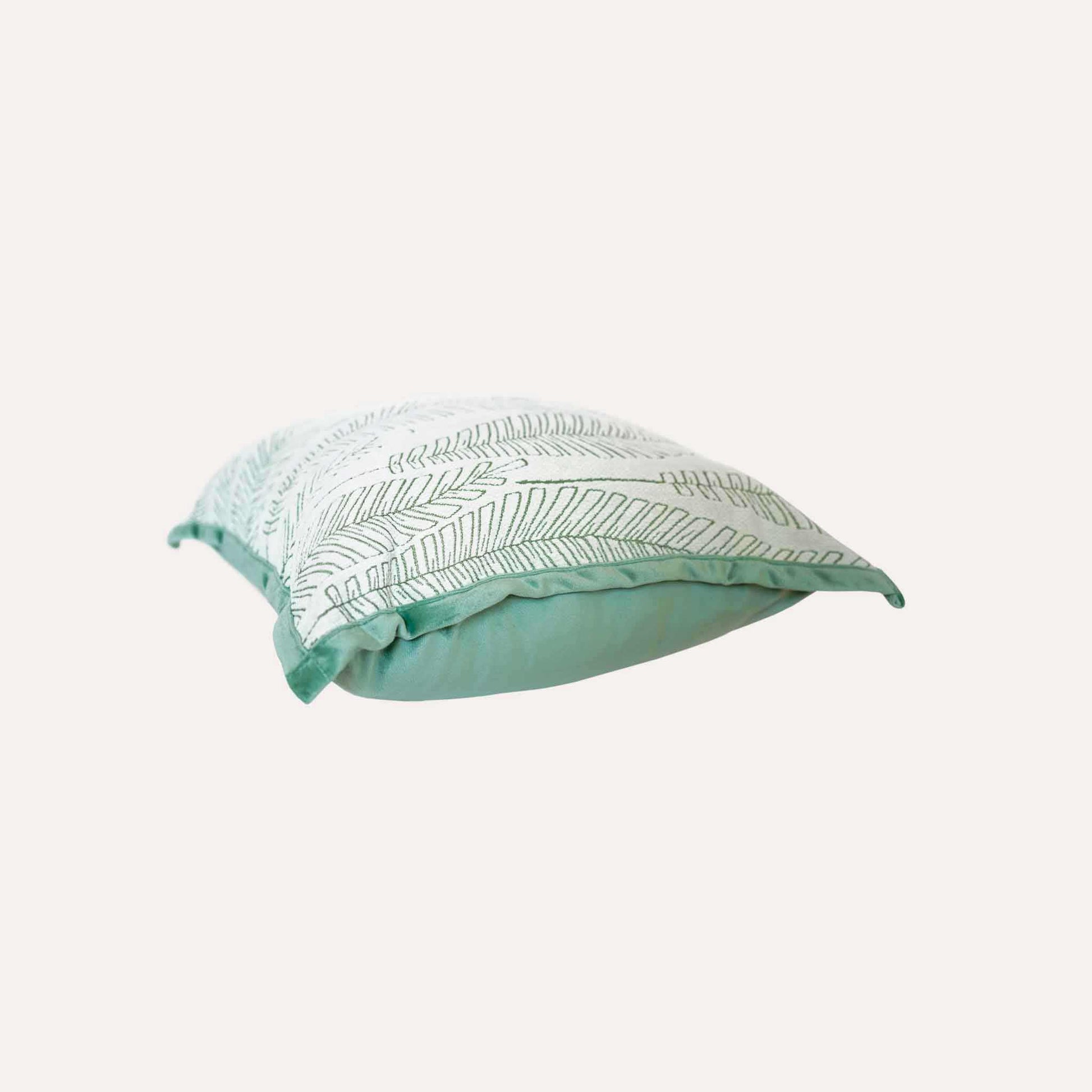 Vibrant green and white palm leaf jacquard cushion cover.