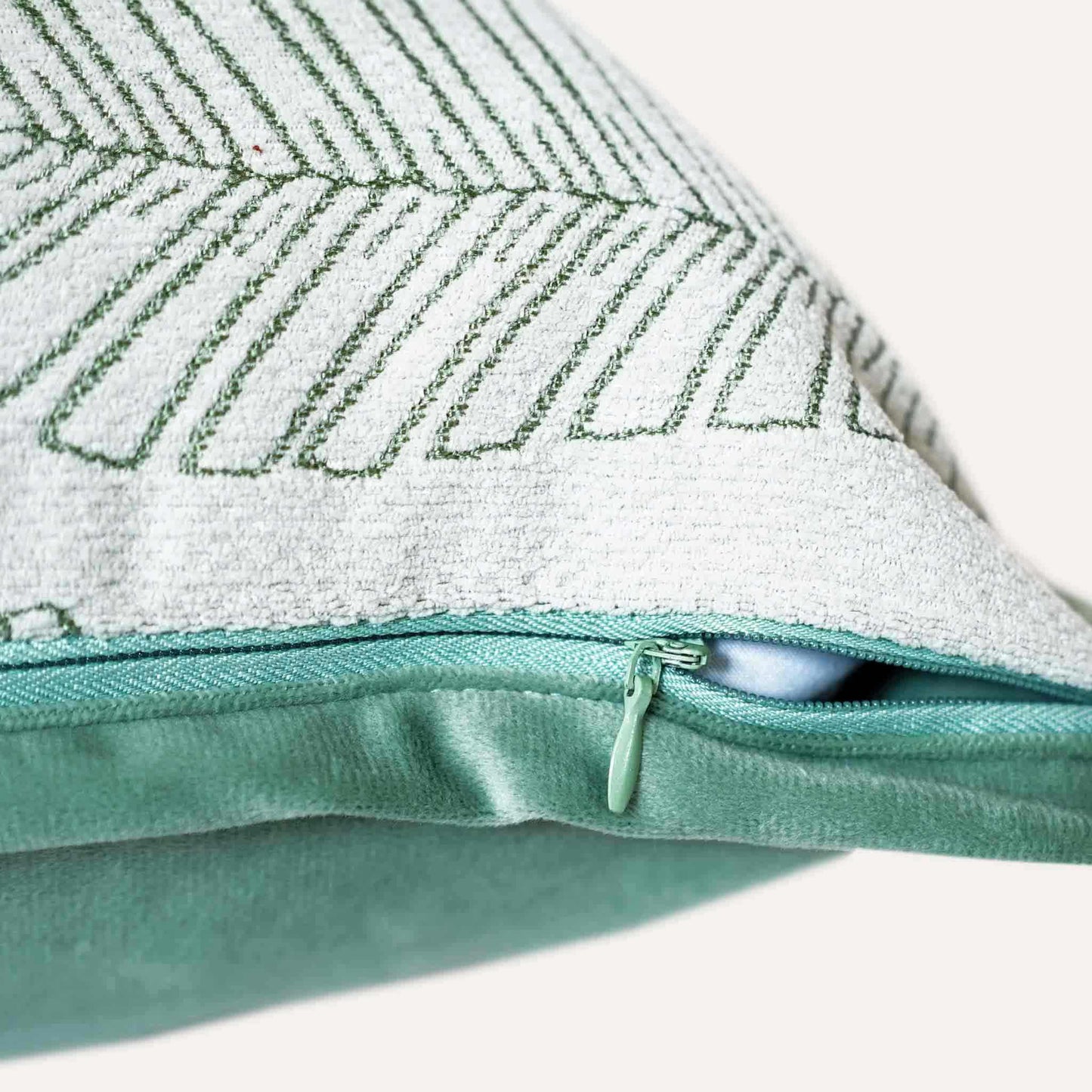 Vibrant green and white palm leaf jacquard cushion cover with invisible zipper.