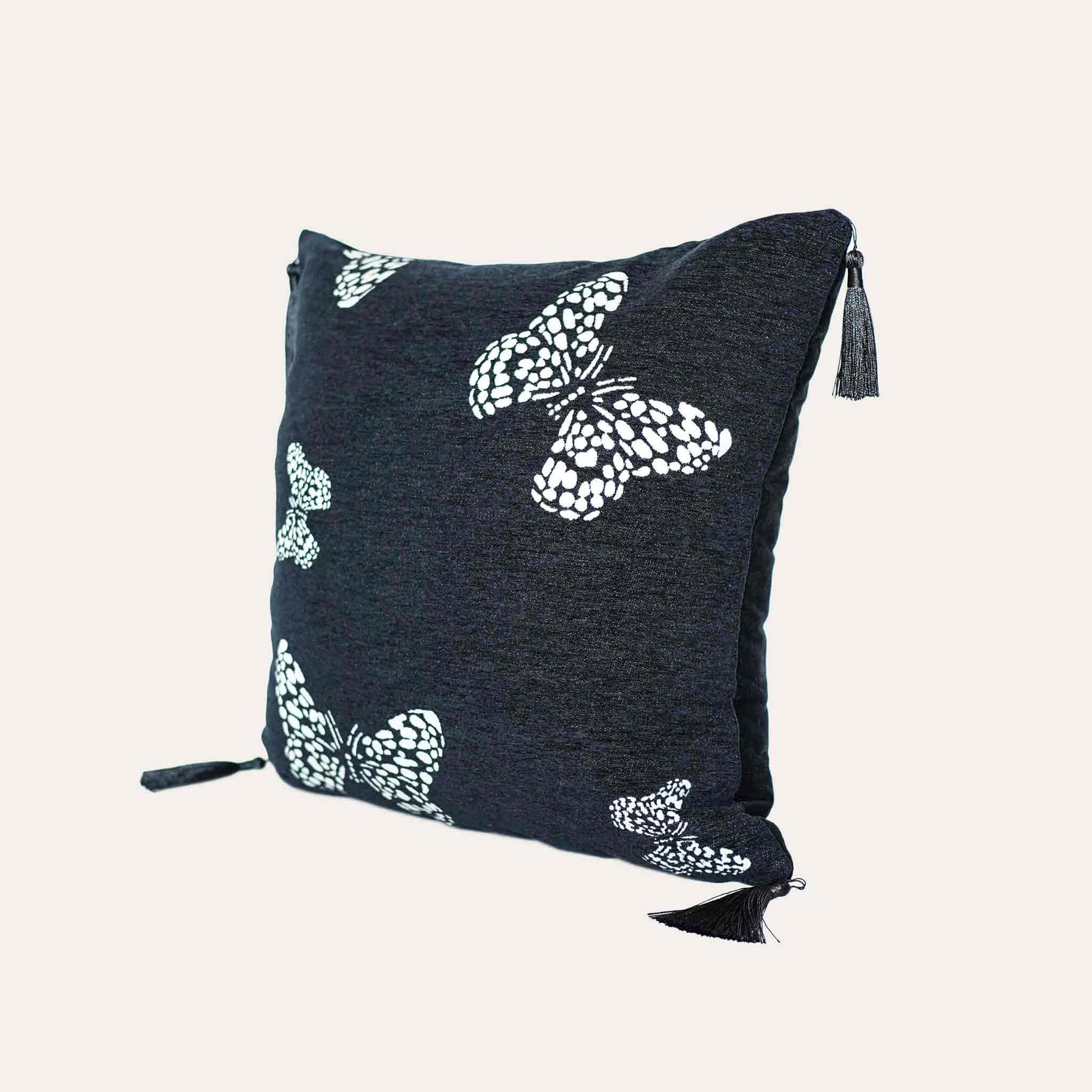 White butterfly on black background, fringed chenille cushion cover.