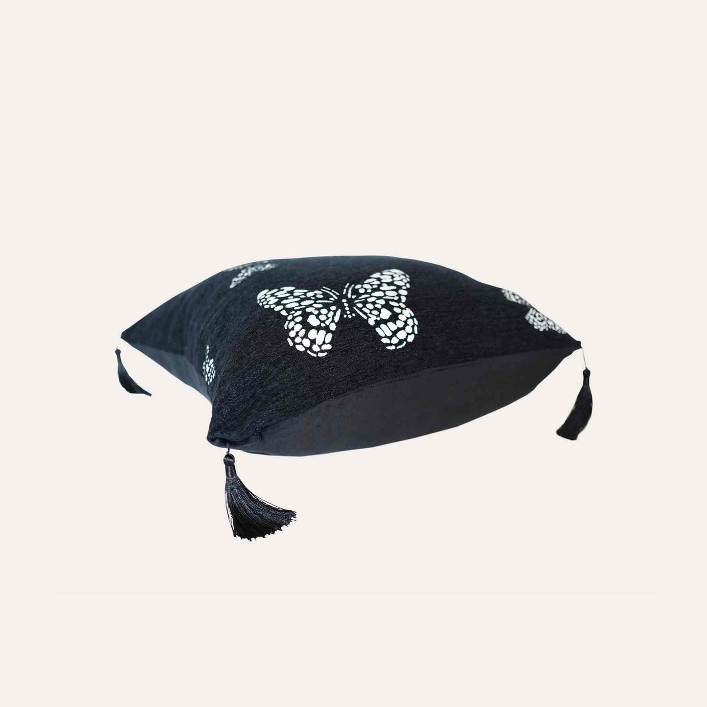 White butterfly on black background, fringed chenille cushion cover.