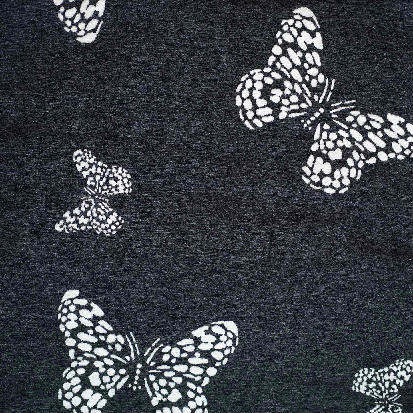 White butterfly on black background, fringed chenille cushion cover.