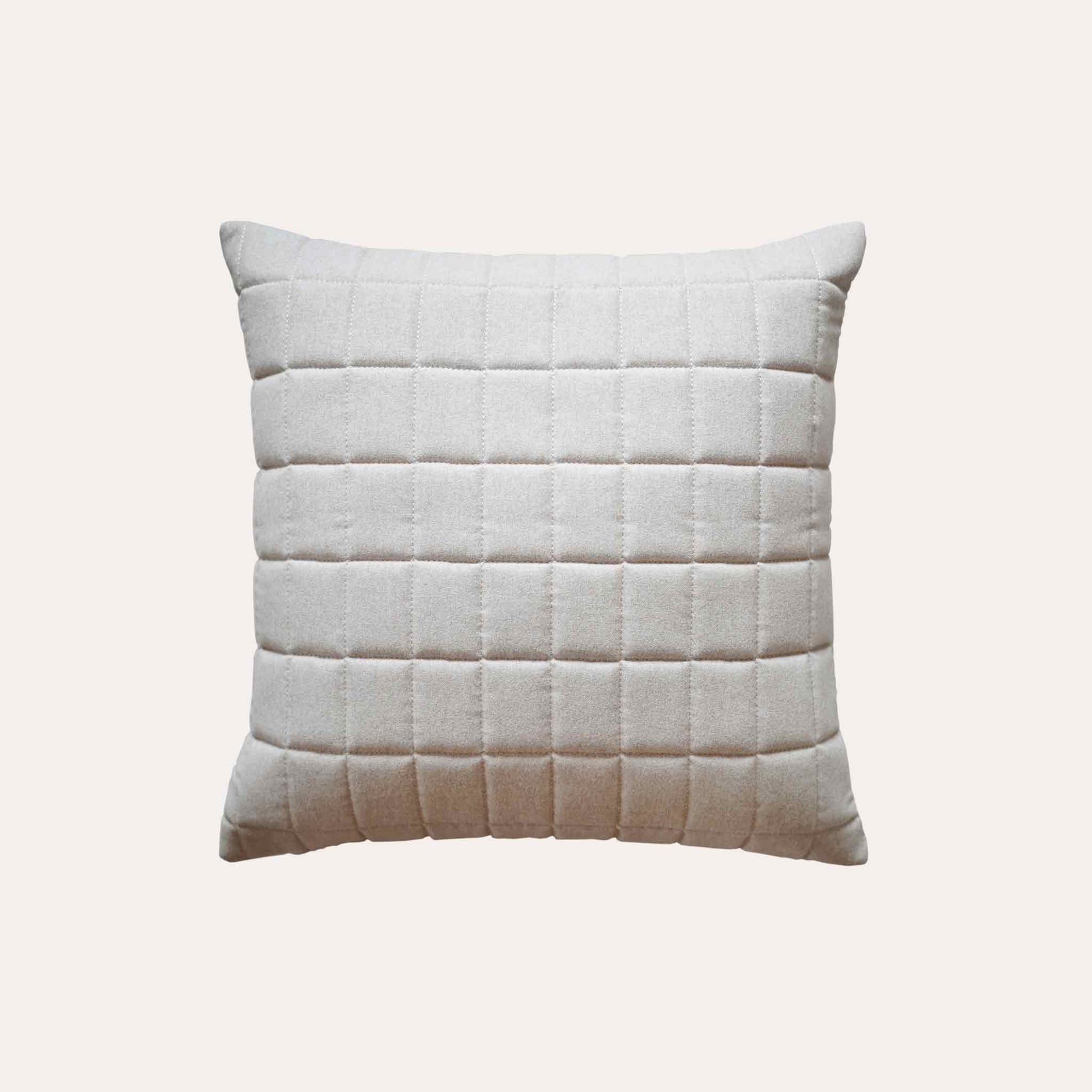 Soft beige quilted showcasing a geometric design cotton cushion cover.
