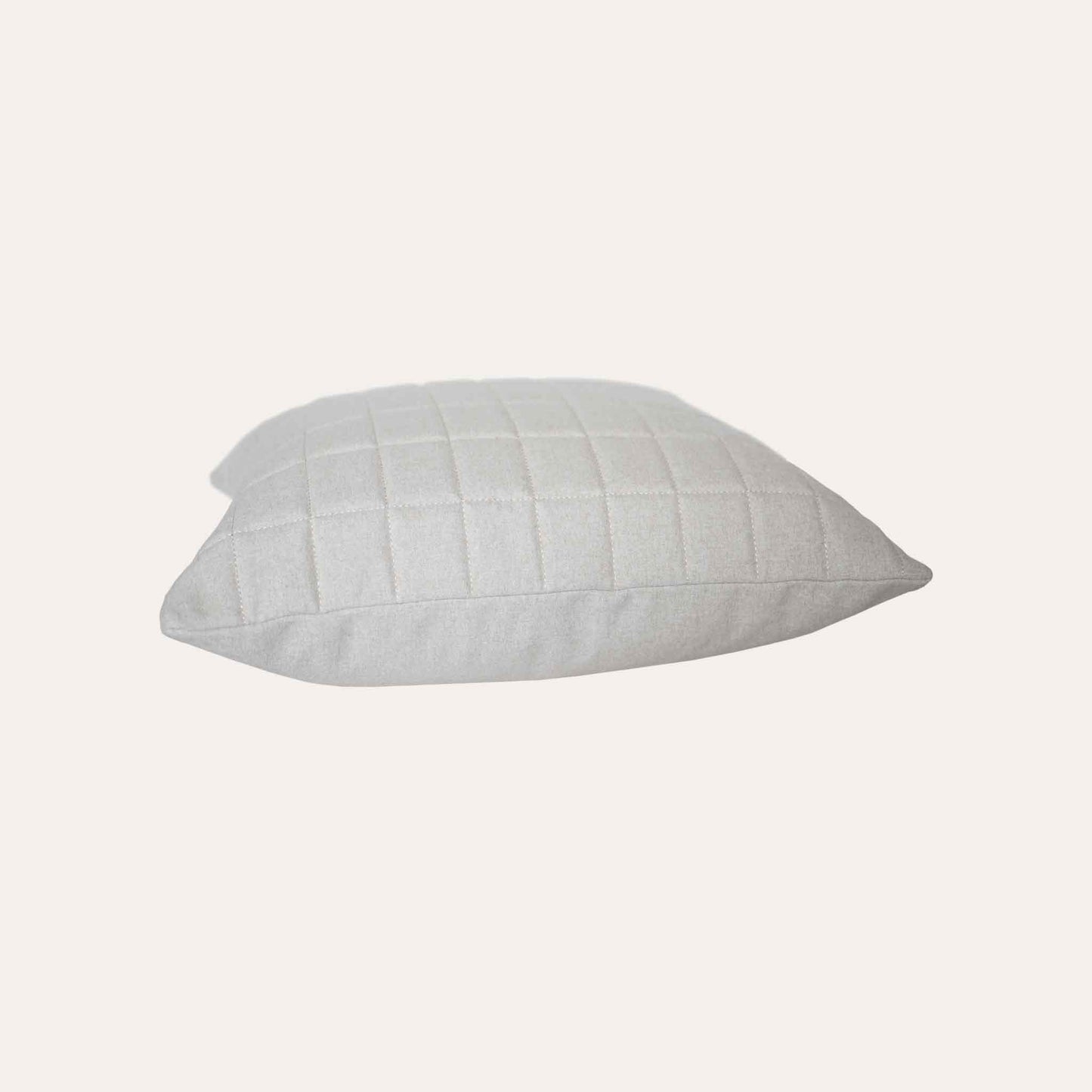 Soft beige quilted showcasing a geometric design cotton cushion cover.
