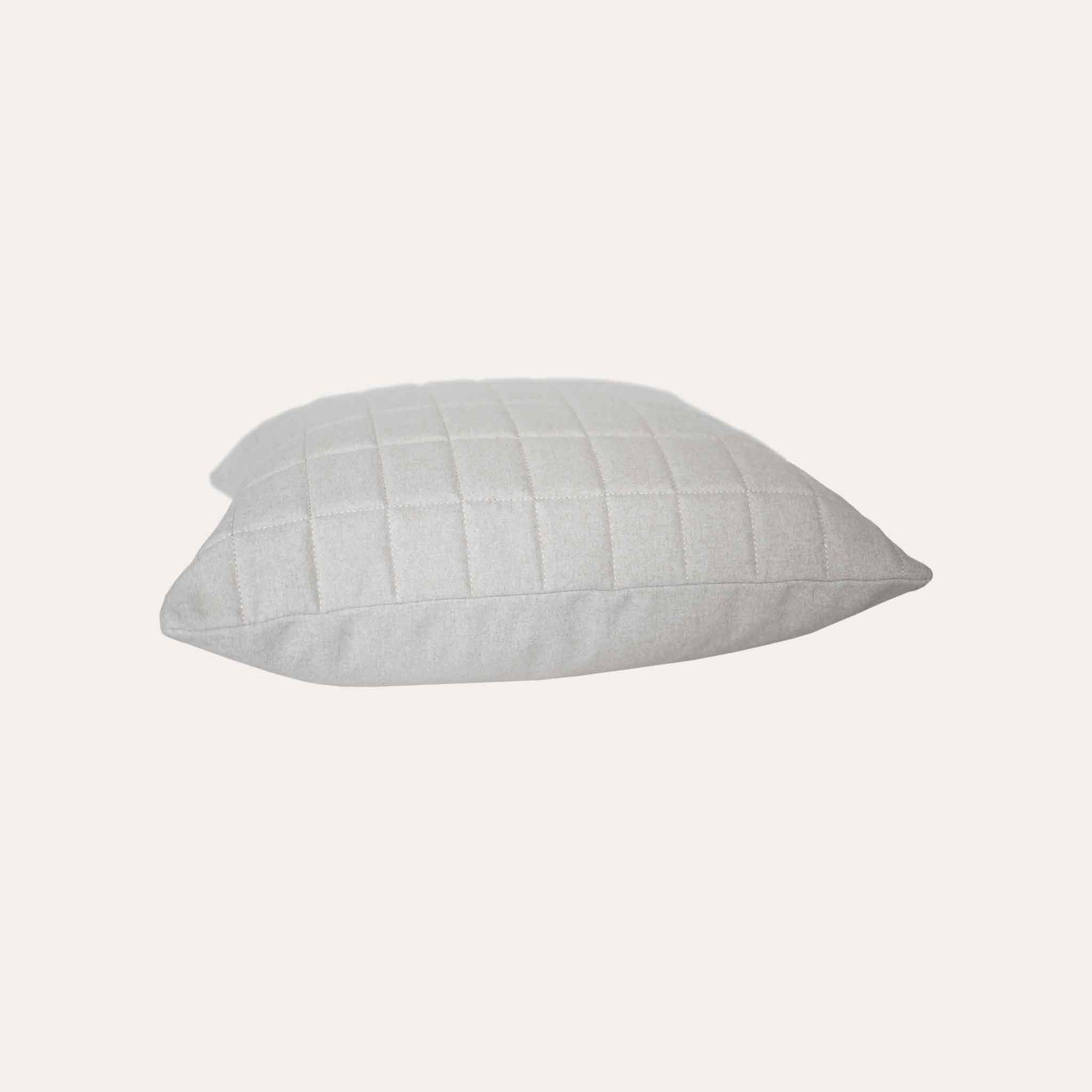 Soft beige quilted showcasing a geometric design cotton cushion cover.