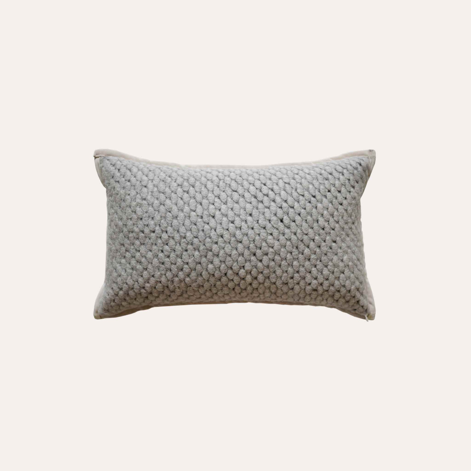 Grey woven textured wool lumbar cushion cover.