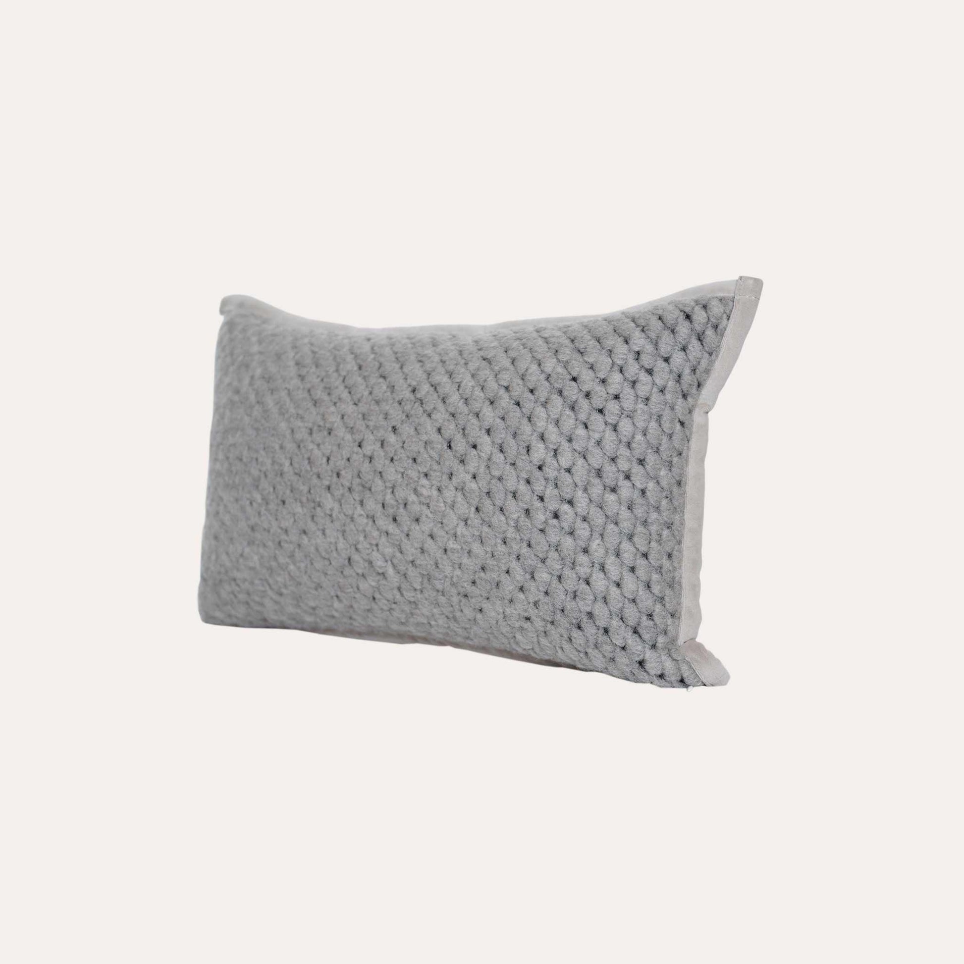 Grey woven textured wool lumbar cushion cover.
