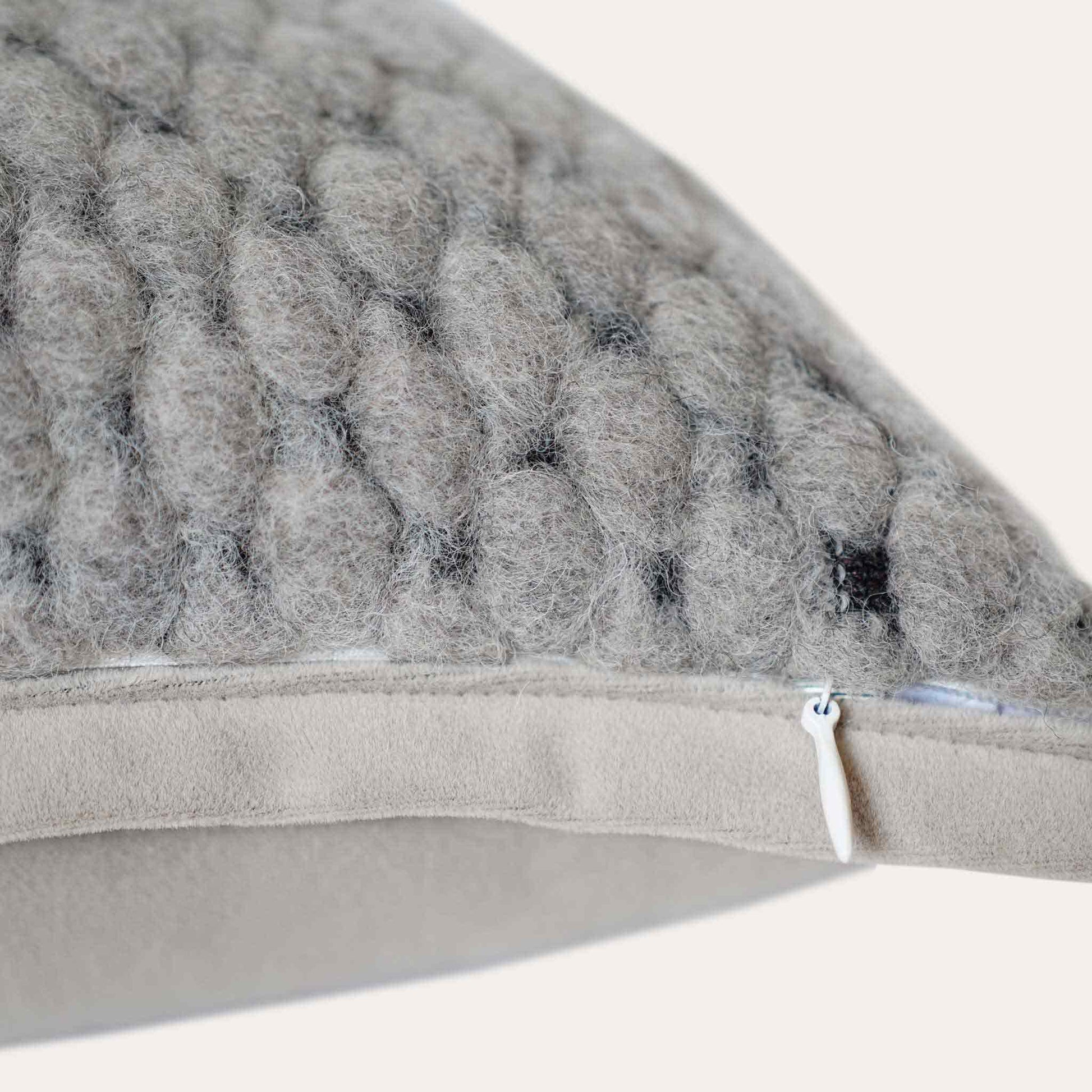 Grey woven textured wool lumbar cushion cover with invisible zipper.