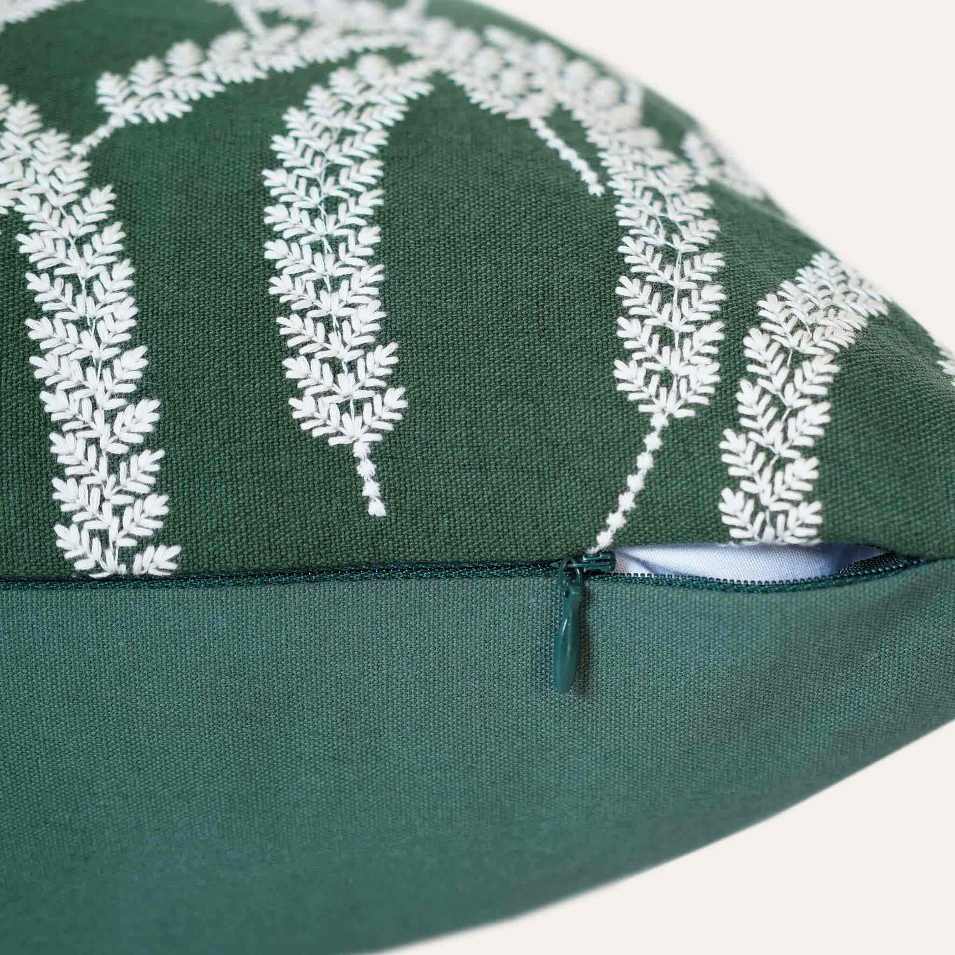 White straw embroidered dark green background cushion cover with invisible zipper.