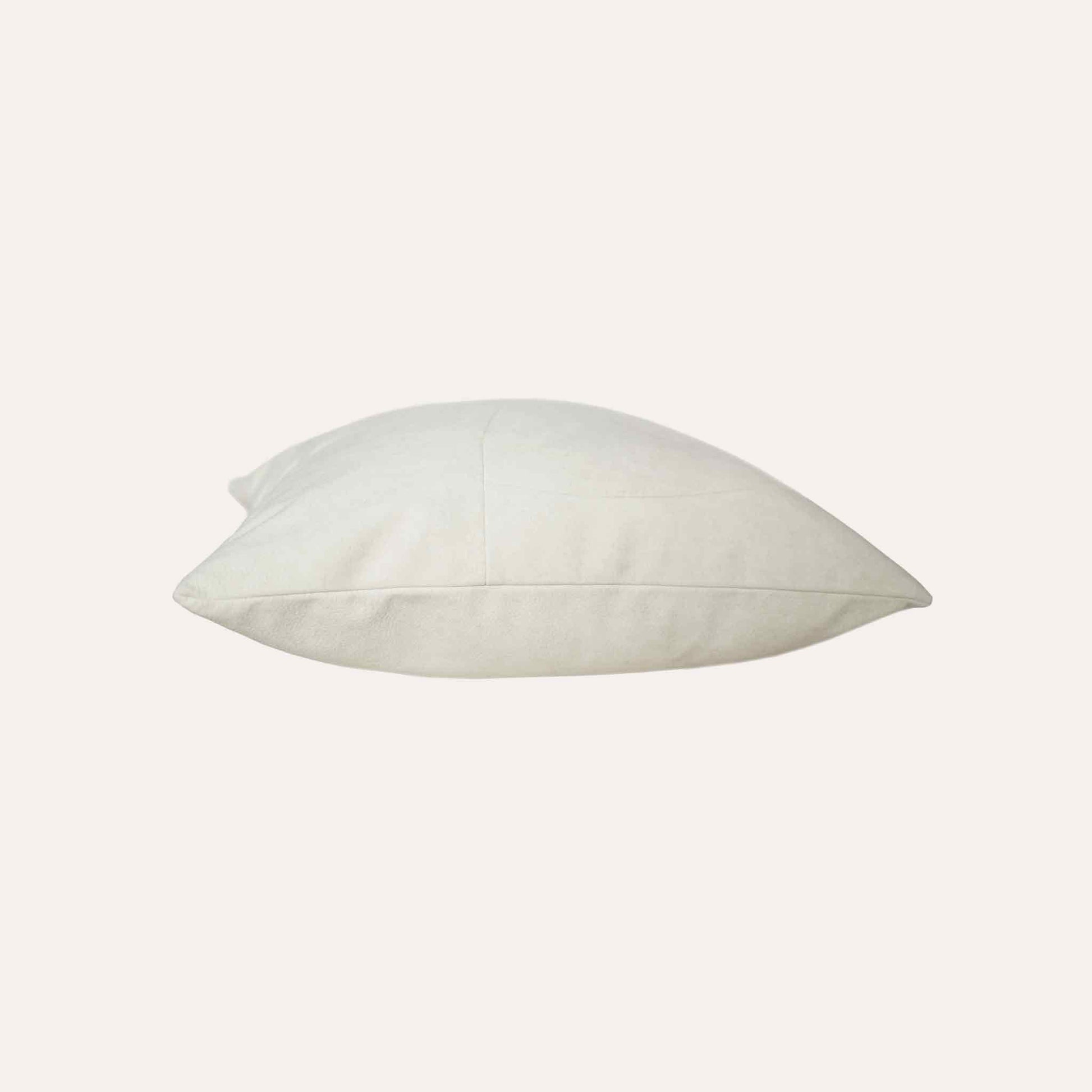 Chic white curved patchwork cushion cover.
