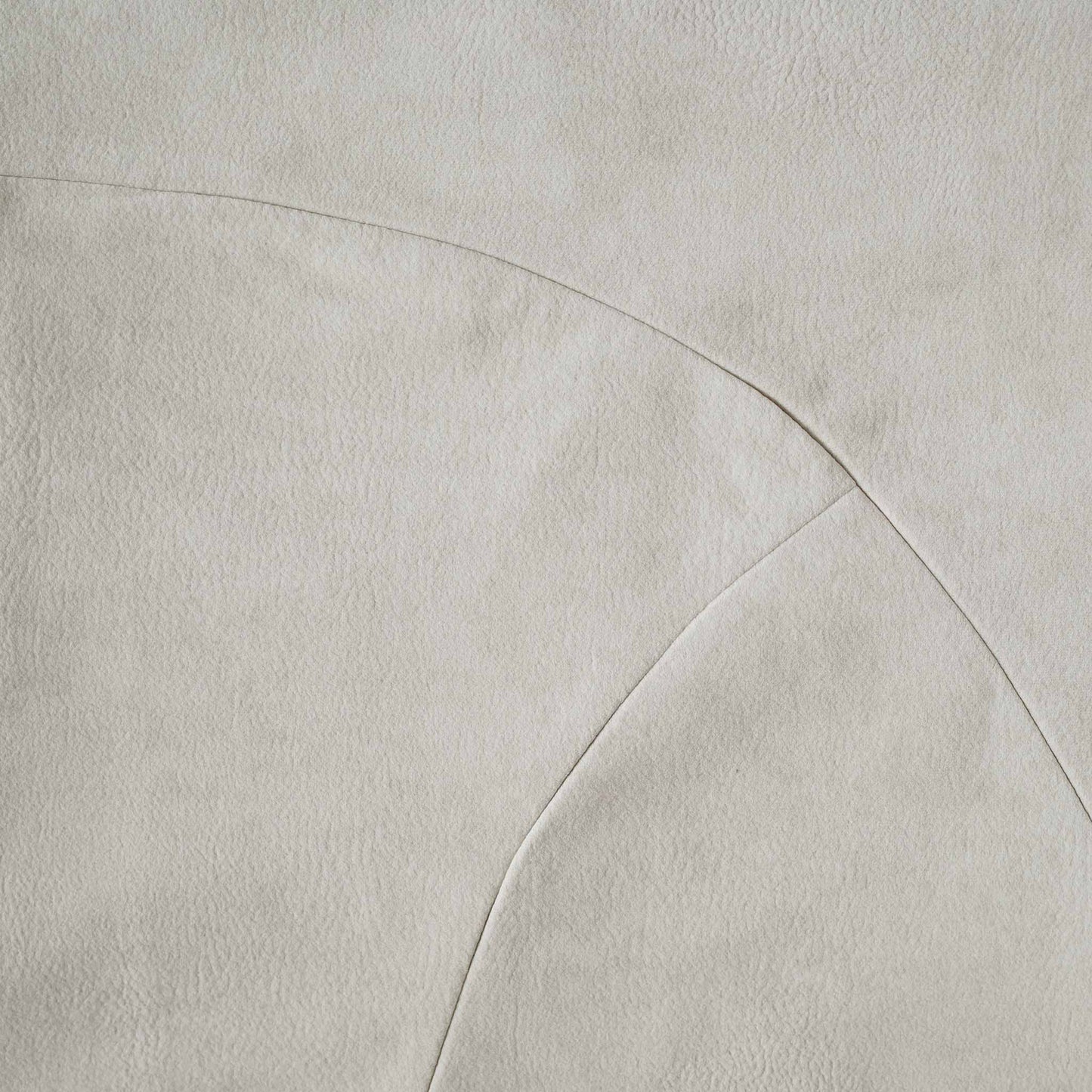 Chic white curved patchwork cushion cover.