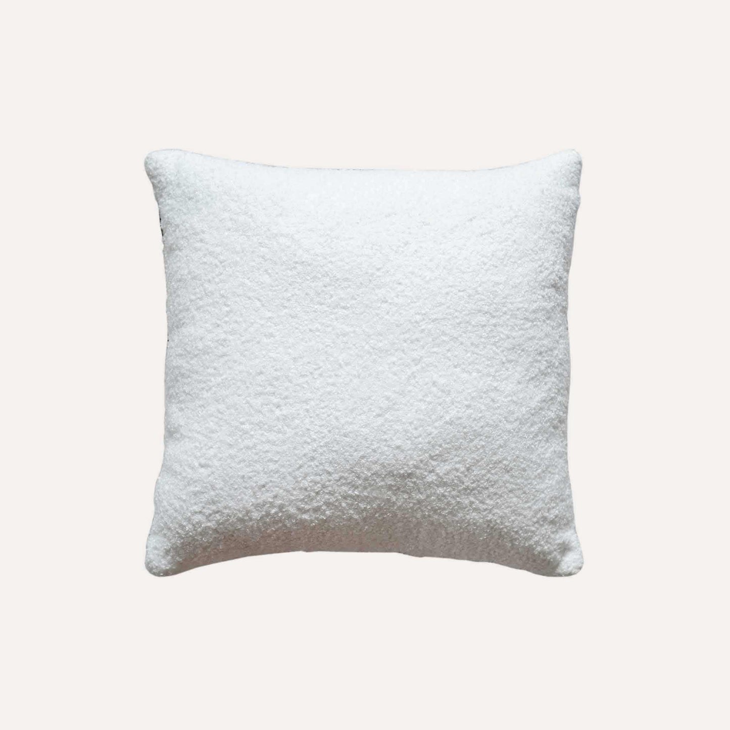 Modern wool cushion in black and white ribbon pattern with a solid white back.