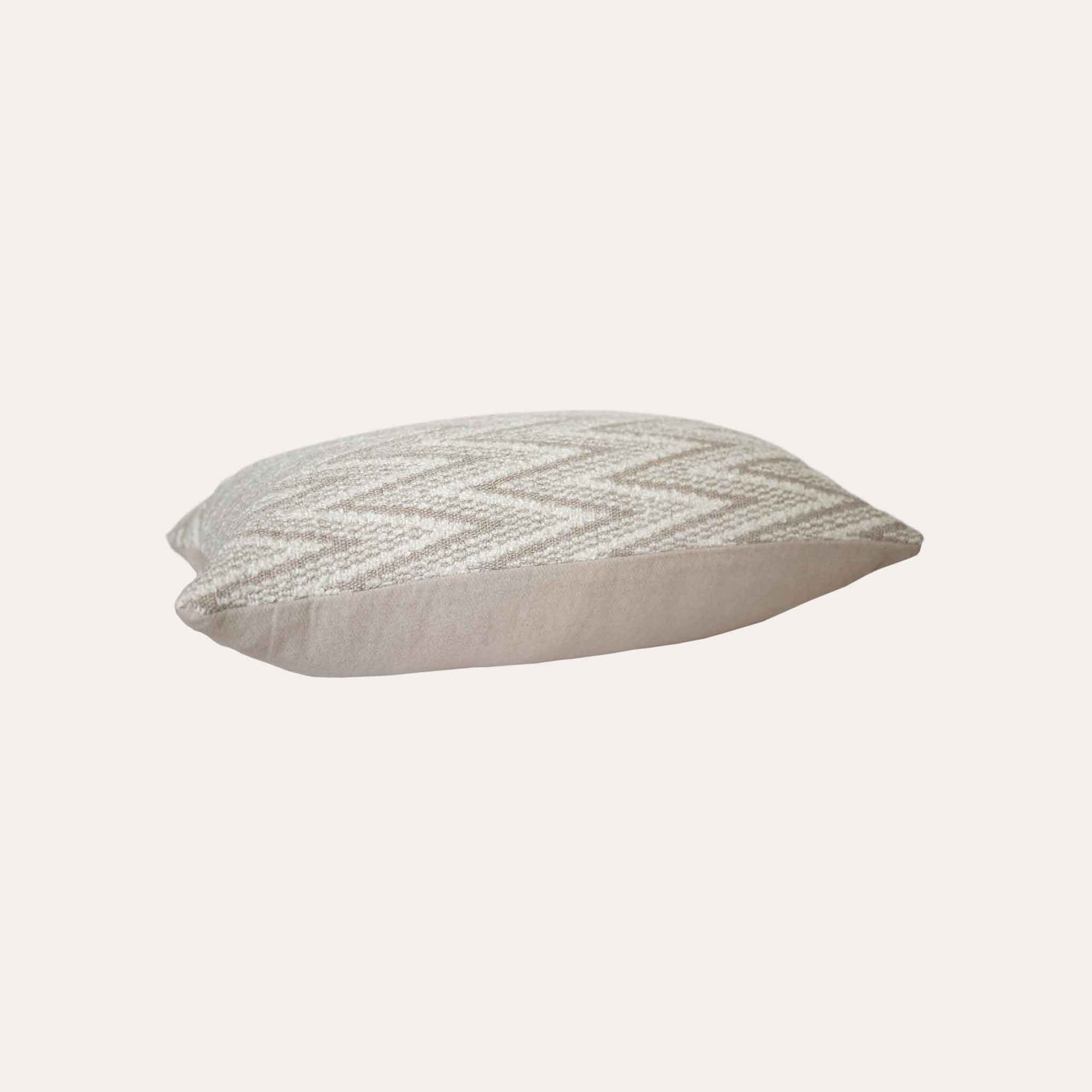 White and beige serrated pattern woolen decorative cushion cover.