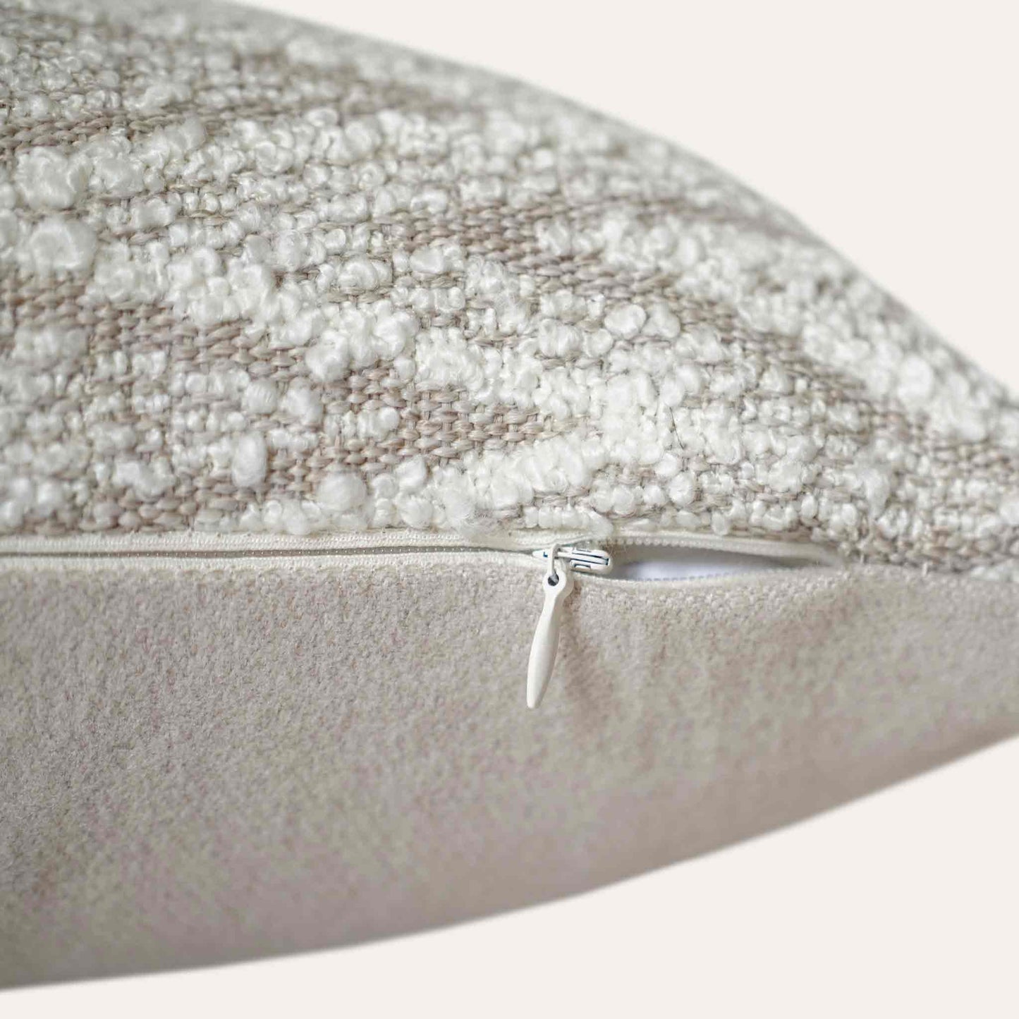 White and beige serrated pattern woolen decorative cushion cover with invisible zipper.