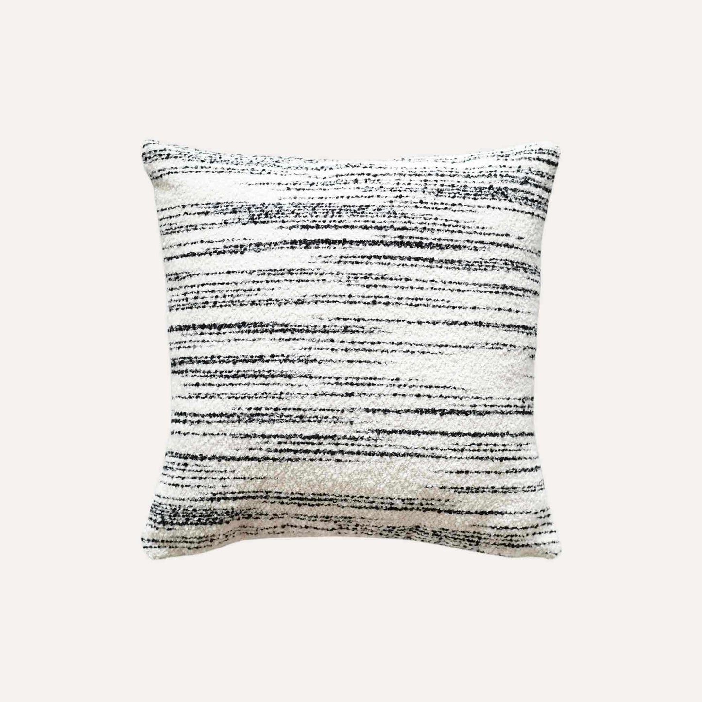 White wool cushion with black crayon strokes.