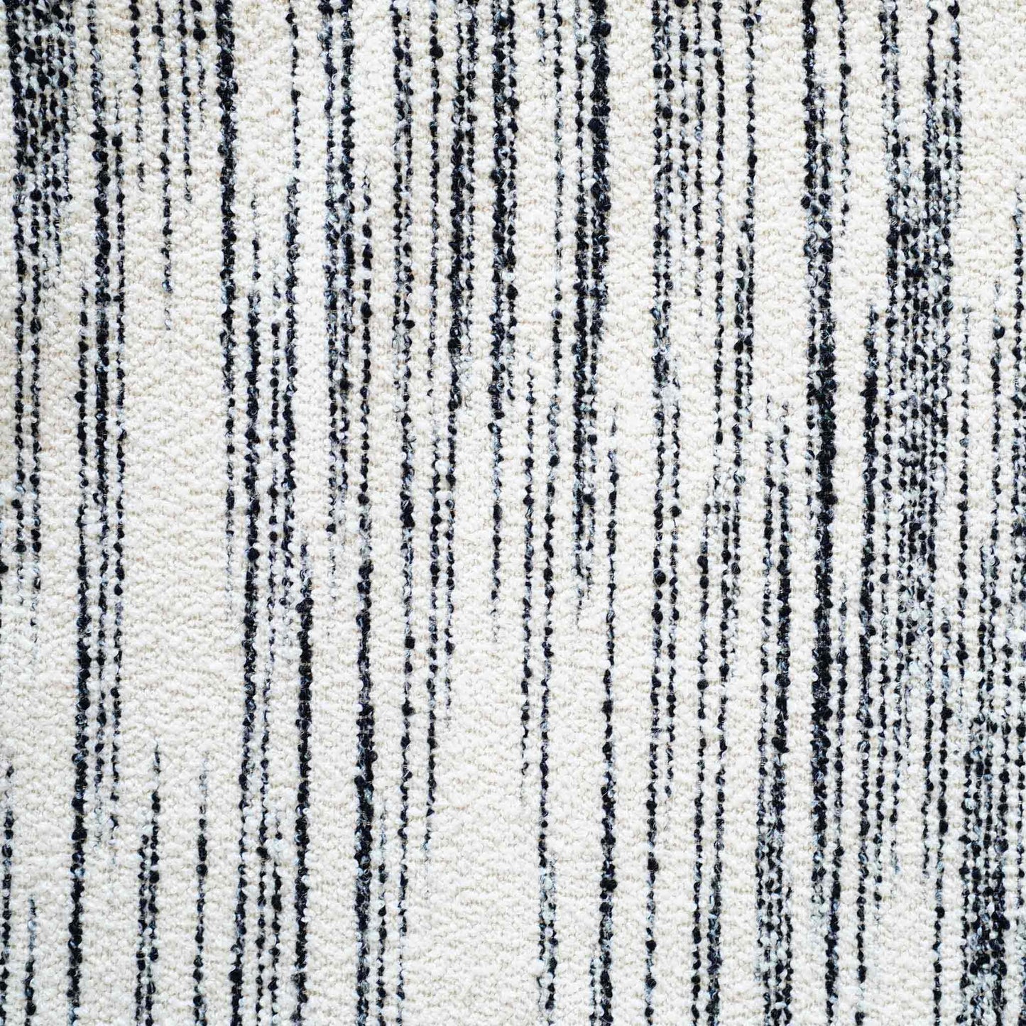 White wool cushion with black crayon strokes.