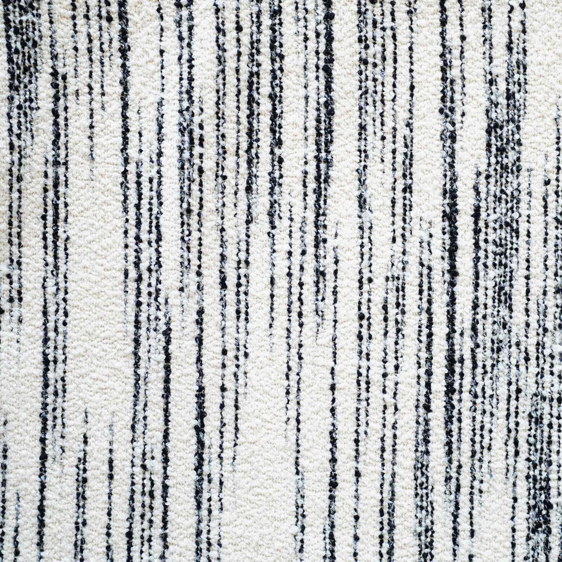 White wool cushion with black crayon strokes.