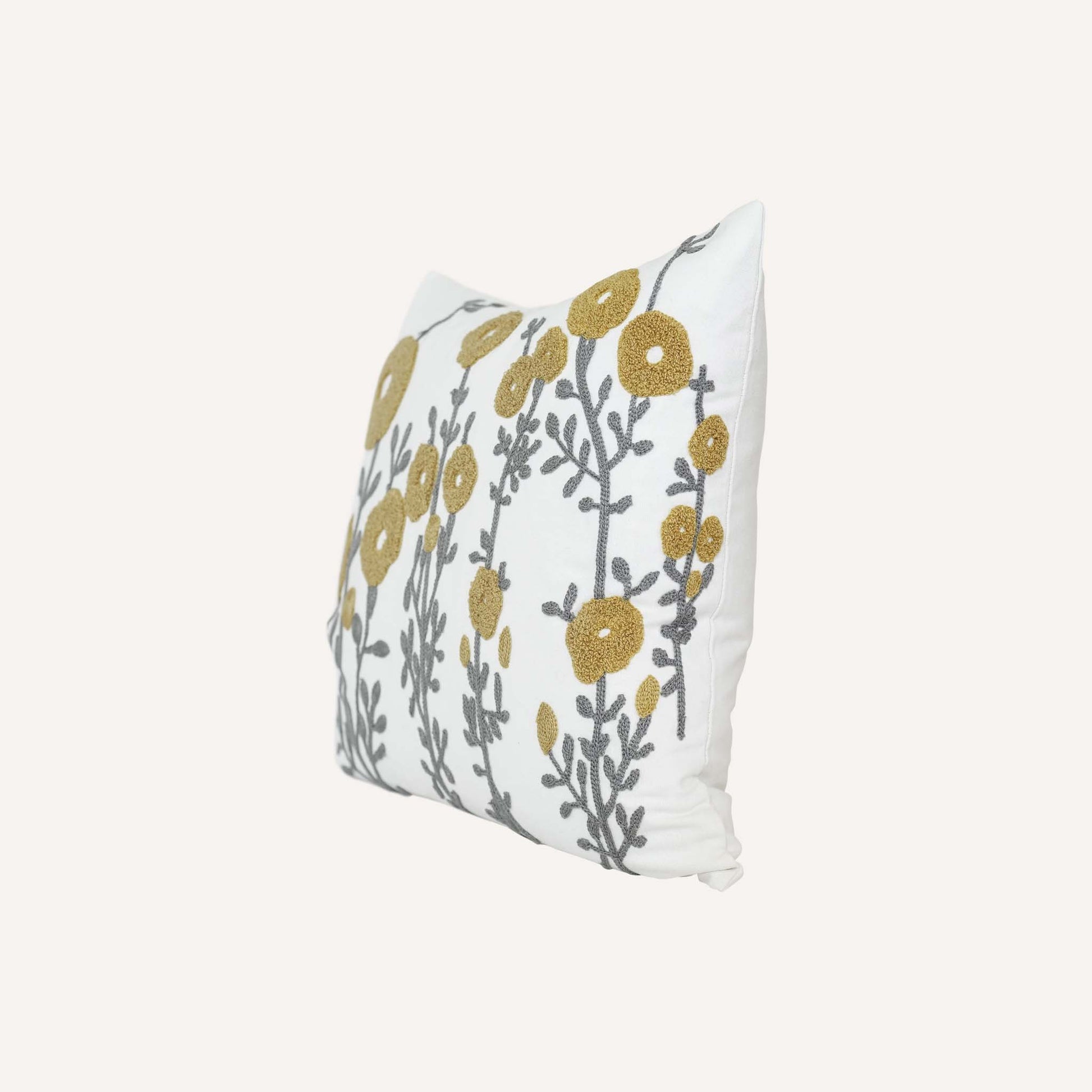 Tufted yellow flower cushion on white background.
