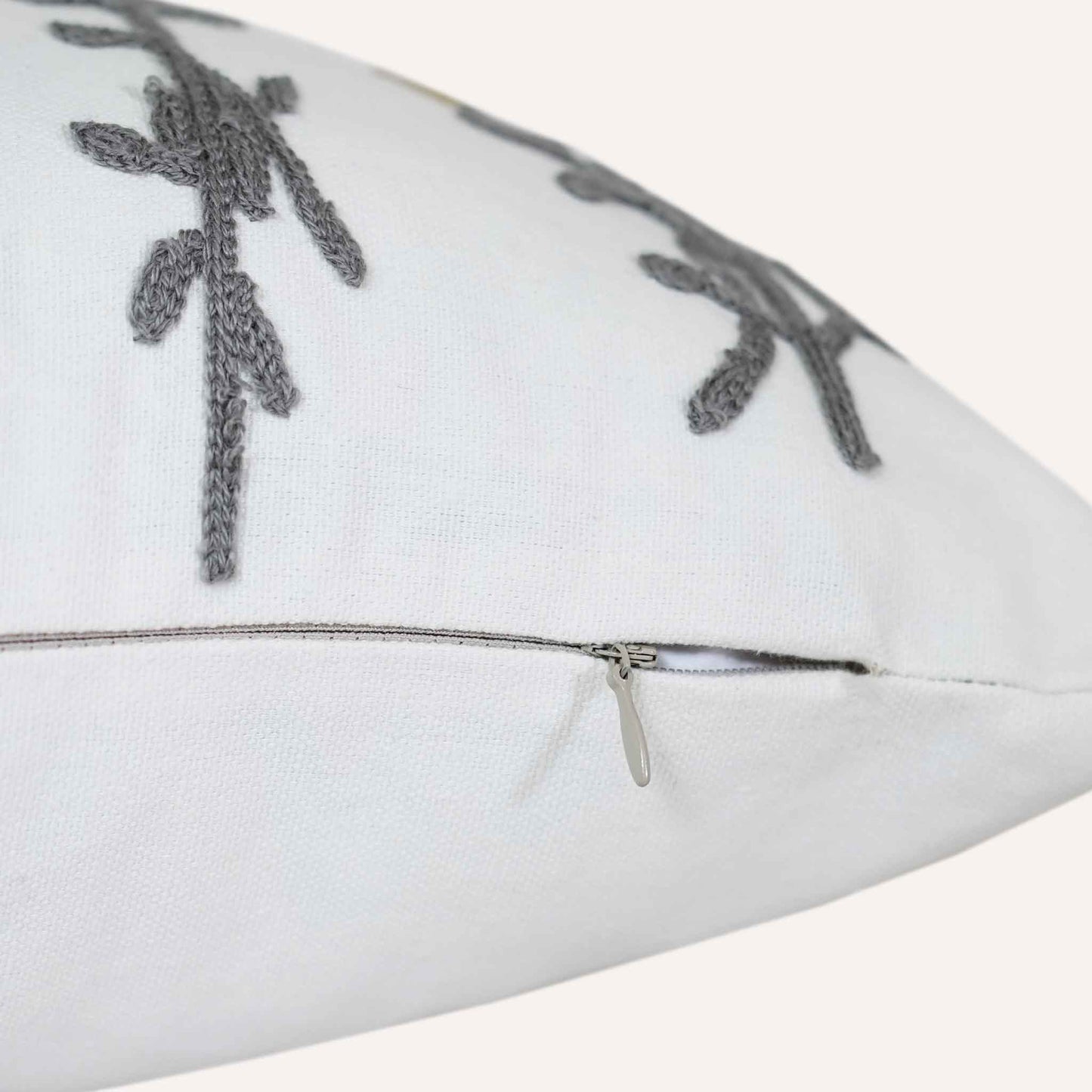 Invisible zip close-up of tufted yellow flower cushion on white background.