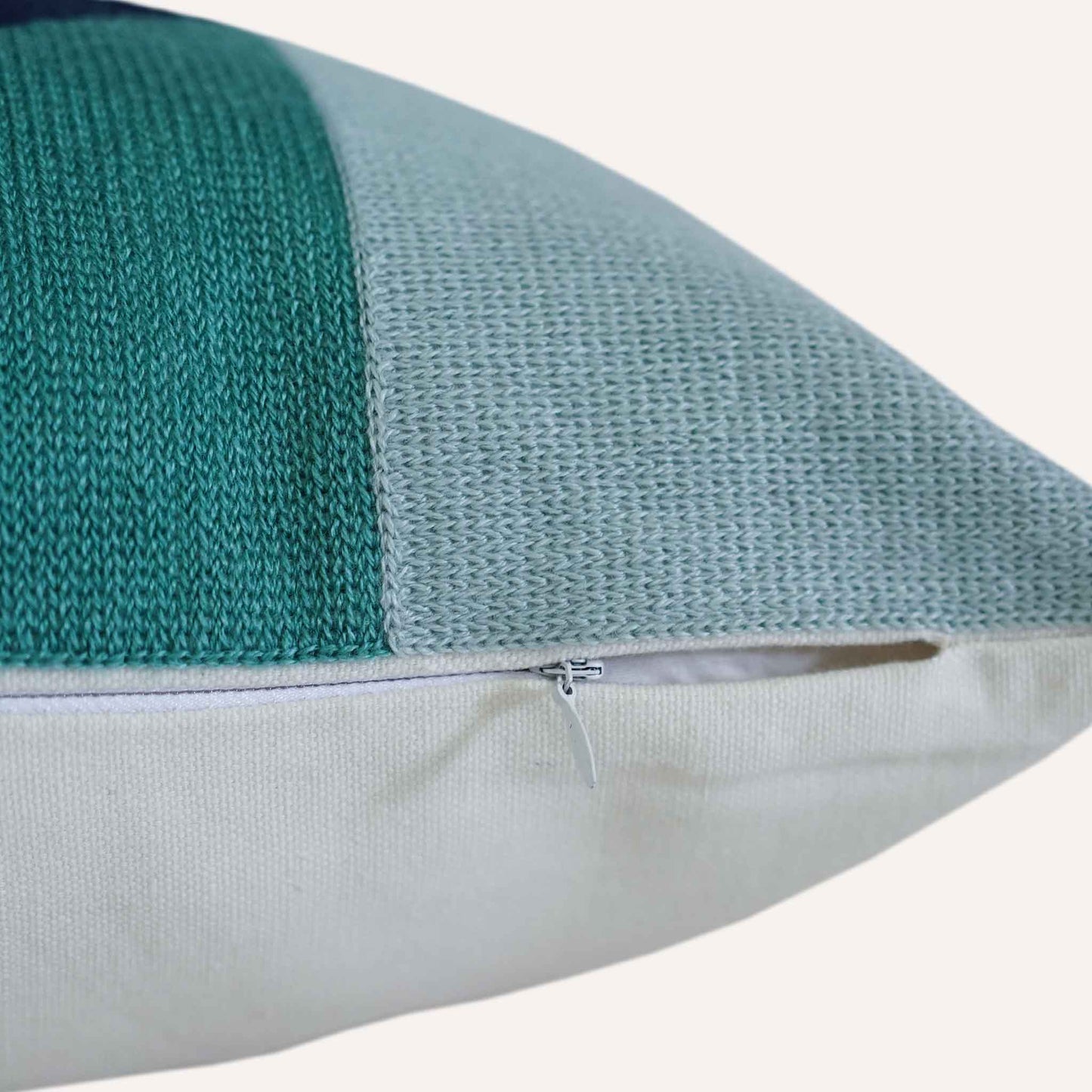 Close up of yellow, green, grey embroidered cushion with invisible zip.