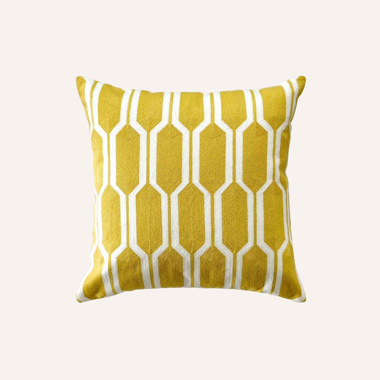 A yellow and white geometric cushion with a modern design using bold shapes and lines.