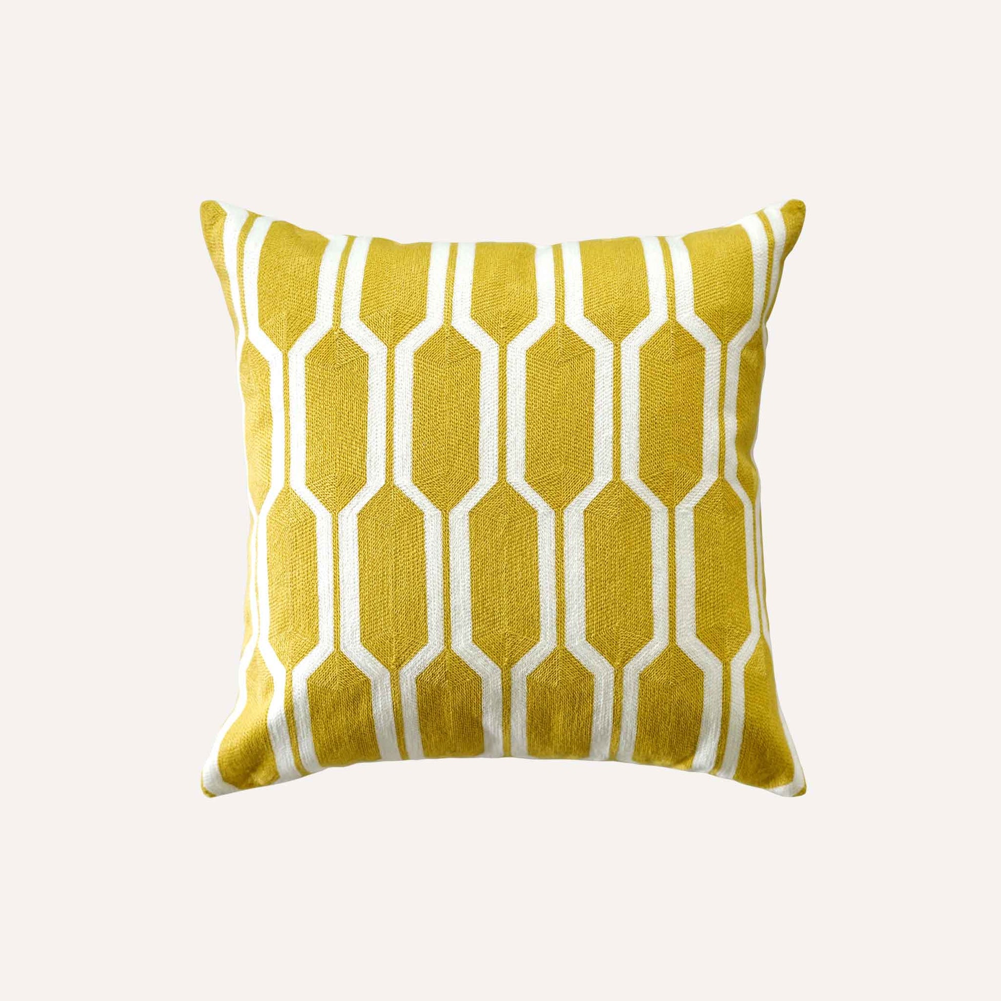 A yellow and white geometric cushion with a modern design using bold shapes and lines.
