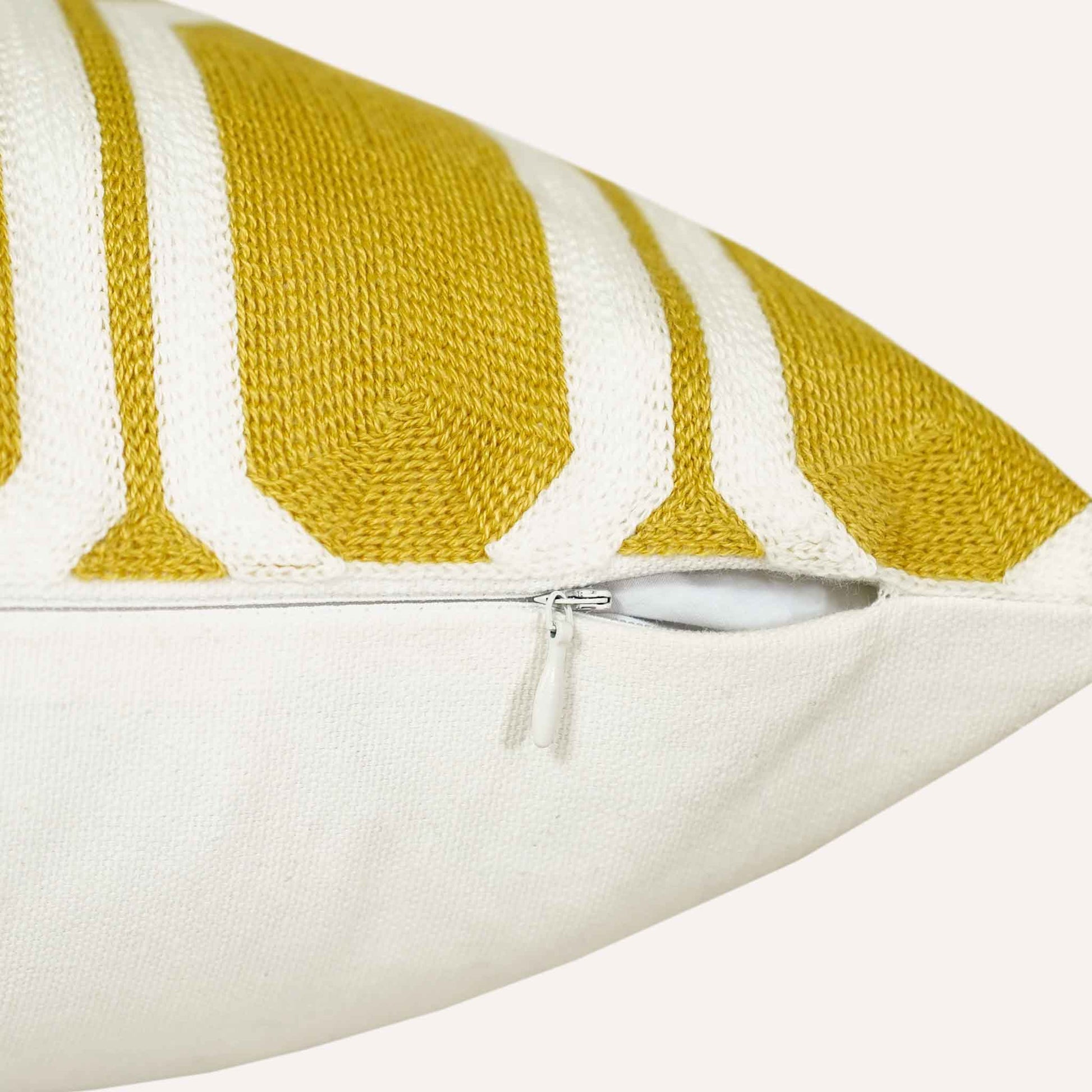 Close-up of the invisible zip on the yellow and white geometric cushion.